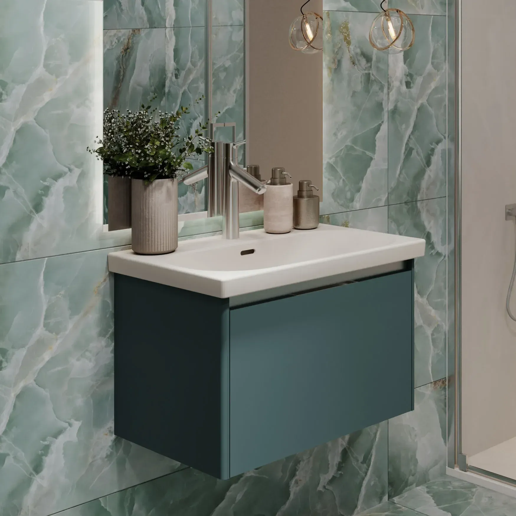 Blue wall hung vanity unit with integrated white basin, chrome mixer tap, illuminated mirror, green marble-effect wall tiles and contemporary walk-in shower from Island Bathrooms.